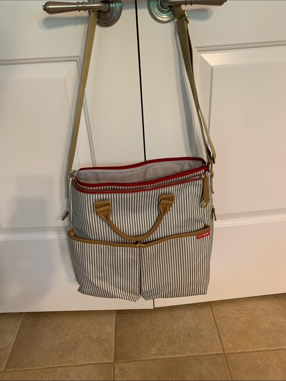 Skip Hop Striped Crossbody Bag with Red Zipper and Tan Accents